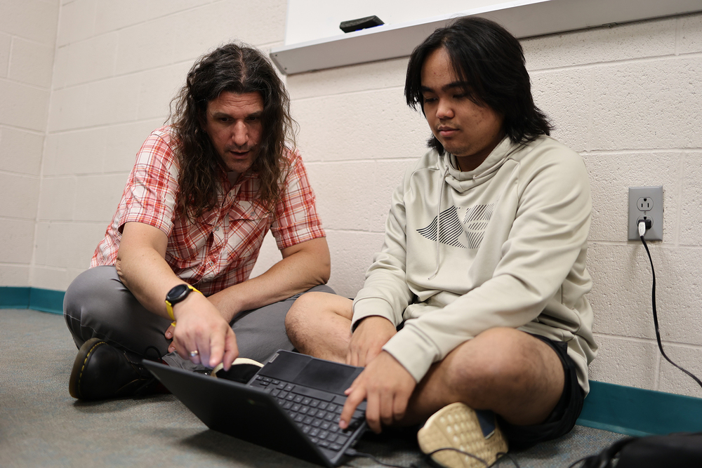 Allegan High School math teacher Chris Conrad explains a concept to senior John Derek Kaw.