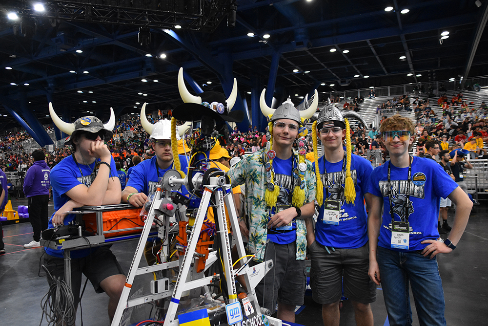 Students in blue shirts and Viking horn hats