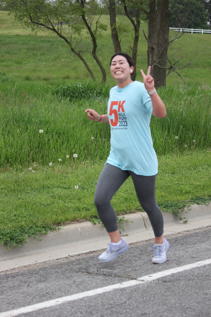 Female runner flashing peace sign